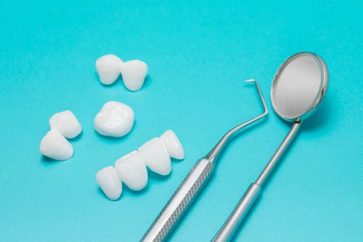 A pair of tooth brushes and dental tools on top of a table.