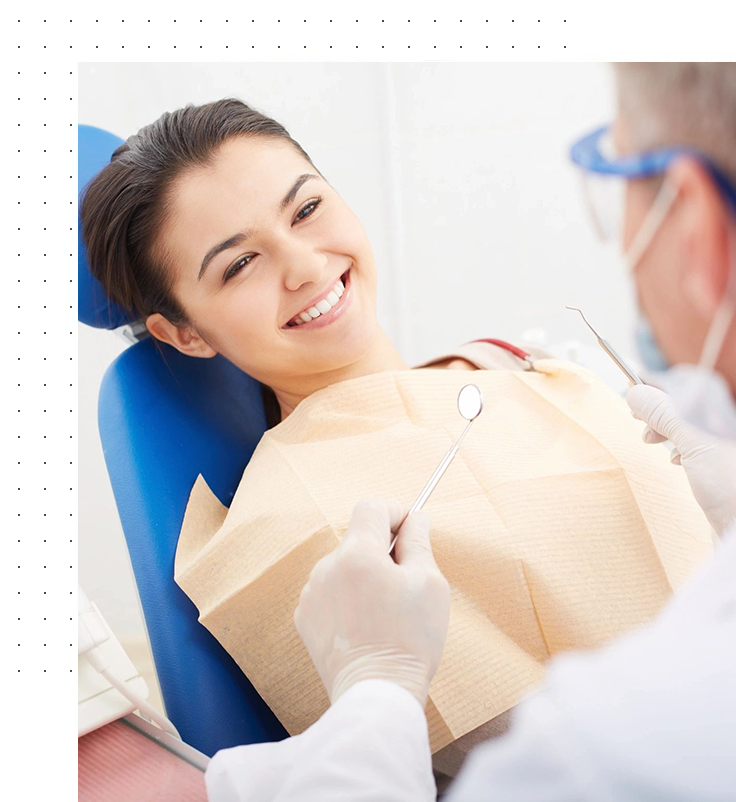 A woman sitting in the dentist chair with a bag of food.